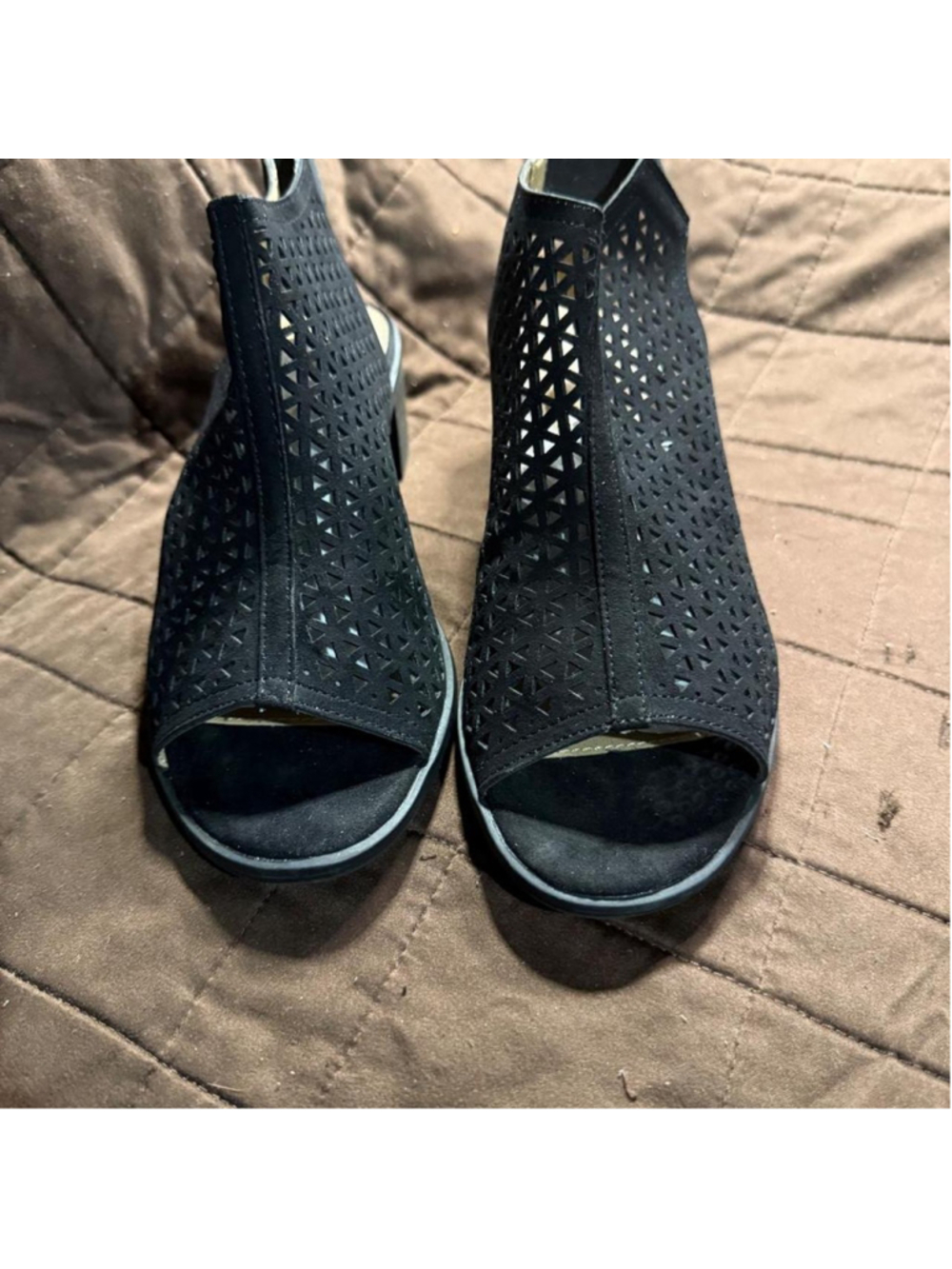 Black perforated ankle boots with geometric cut-out pattern #ankleboots #geometr